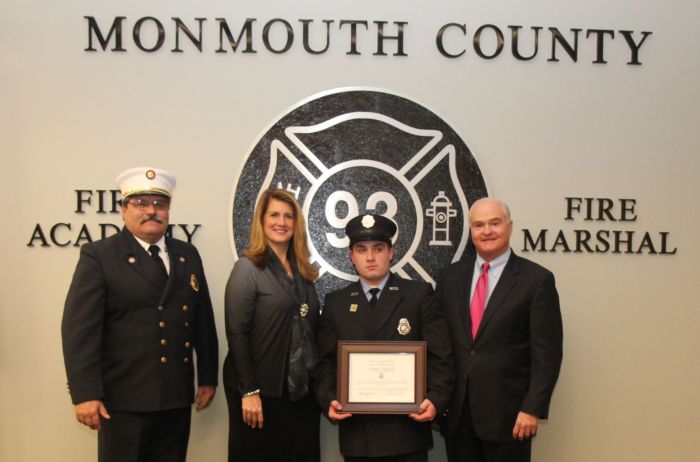 Fire Marshal Henry Styker III, Freeholder Serena DiMaso and Freeholder John P. Curley congratulate Timothy J. Smigelsky of the Ramtown Fire Company of Howell, who was the recipient of the Class 101 Ronald Fitzpatrick Award.